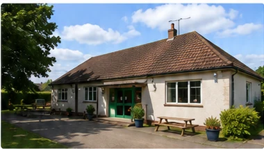 Example community hall with a tiled roof and green entrance doors